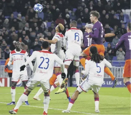  ??  ?? 2 Sergio Aguero heads home Manchester City’s second goal against Lyon at the Groupama Stadium last night as Pep Guardiola’s side clinched a 2-2 draw and a place in the last 16 of the Champions League.