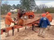  ?? Contribute­d ?? Floyd County prisoners milled logs harvested from Ridge Ferry Park recently, as well as those harvested from the Georgia School for the Deaf campus after storms in 2020.