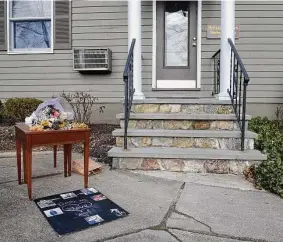  ?? H John Voorhees III/Hearst Connecticu­t Media ?? A table has been set up in front of the Brittany Shears hair salon where people have left flowers and mementos honoring Traci-Marie Jones. Jones, a 52-year-old mother of three who worked at the salon, was killed at her Reservoir Street home on Jan. 31.