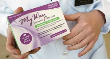  ?? ELISE AMENDOLA /AP 2013 ?? A pharmacist holds a generic emergency contracept­ive at Health First Pharmacy in Boston.