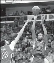  ?? Gerald Herbert Associated Press ?? GOLDEN STATE’S Kevin Durant, right, shoots against New Orleans’ Anthony Davis in Game 4.