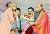  ?? — DC ?? D. Arvind, son of TRS MP D. Srinivas, felicitate­s Union home minister Rajnath Singh at Nizamabad. Mr Arvind joined the BJP at the event.