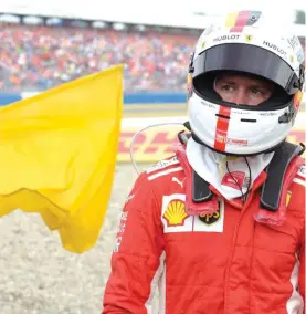  ??  ?? Ferrari driver Sebastian Vettel of Germany walks back to his pits after he crashed into the track wall Photo: AP