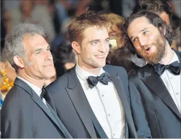  ?? Loic Venance AFP/Getty Images ?? “GOOD TIME” co-writer Ronnie Bronstein, left, star Robert Pattinson, co-director Josh Safdie at Cannes.