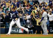  ?? ASSOCIATED PRESS ?? MILWAUKEE BREWERS’ BRANDON WOODRUFF reacts after hitting a home run in game Game 1 of the National League Championsh­ip Series Friday in Milwaukee.