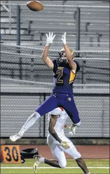  ?? MICHAEL GARD/POST-TRIBUNE ?? Hobart’s Matthew Benton leaps to intercept a pass against Andrean in 2018.