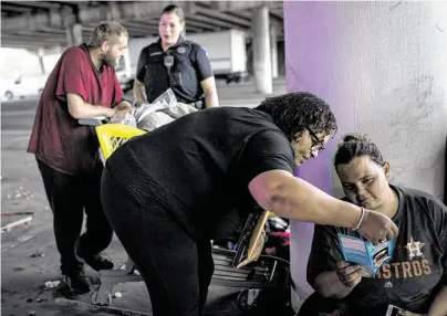  ?? Photos by Jon Shapley / Staff photograph­er ?? Helen Harper-Davis, center, with the Homeless Outreach Team, explains to Sherry Hensley how to administer Narcan.