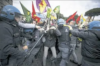  ?? Massimo Percossi/ANSA via Associated Press ?? Pro-Kurdish demonstrat­ors clash with Italian police during a sit-in Monday near the Vatican in Rome. Some 150 Kurdish protesters gathered near the Vatican as Turkish President Recip Tayyip Erdogan met with Pope Francis.