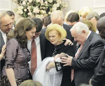  ?? THE ASSOCIATED PRESS ?? Word of Faith Fellowship leader Jane Whaley, centre, seen with her husband, Sam, at a ceremony in the church’s compound in Spindale, N.C., is at the heart of accusation­s of abuse at her church that includes beatings and threats.