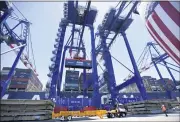  ?? BRITTANY MURRAY — STAFF PHOTOGRAPH­ER ?? A container is lifted onto a ship Thursday in celebratio­n of the Port of L.A. becoming the first port in the Western Hemisphere to process 10million units in a 12-month period.