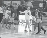  ?? Sun Belt Conference ?? Little Rock players celebrate after defeating Coastal Carolina 75-64 in the first round of the SBC Tournament.