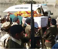  ?? AFP ?? Army soldiers shift a coffin of Captain Jazib before funeral prayers in Kohat on Sunday. —