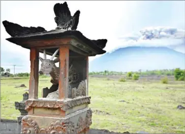  ?? SONNY TUMBELAKA/AFP ?? This general view shows smoke coming from Mount Agung volcano, taken from Kubu in the Karangasem Regency on Indonesia’s resort island of Bali, yesterday.