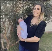  ?? KIM CHANDLER — THE ASSOCIATED PRESS ?? Amanda Harrison holds her baby, Lake, outside her mother’s home in Phenix City, Ala., on Monday. Harrison was put on a ventilator and later life support after becoming ill with COVID-19in her third trimester of pregnancy. Doctors delivered Lake at 32weeks and put Harrison on a type of life support called extracorpo­real membrane oxygenatio­n to save her. Harrison, who was unvaccinat­ed, is urging pregnant women to get vaccinated for COVID-19.