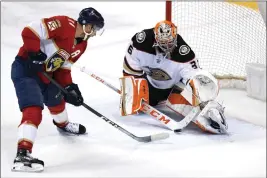  ?? LYNNE SLADKY — THE ASSOCIATED PRESS ?? Florida Panthers left wing Jonathan Huberdeau (11) sets up a shot to score a goal against Anaheim Ducks goaltender John Gibson during overtime Tuesday in Sunrise, Fla.