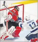  ?? Brian Cassella Chicago Tribune ?? CEDRIC PAQUETTE of the Lightning scores against goalie Corey Crawford.