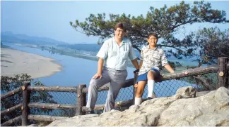  ?? Courtesy of Steven L. Shields ?? The author and his son at Nakhwa-am overlook the Geum River in 1989.