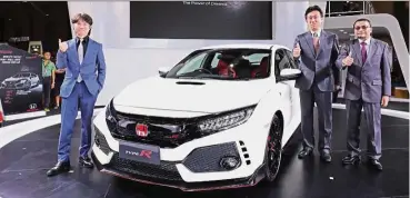  ??  ?? Ishiyama (centre) with president and chief operating officer Roslan Abdullah (right) at the launch of the Civic Type R. With them is the Civic Type R’s Assistant Large Project Leader Hideki Kakinuma.