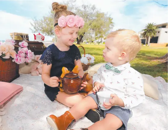  ?? Picture: MIKE BATTERHAM ?? Gold Coast mum Kate Deithe’s children Esme, 4, and Van, 18 months, enjoy a spot of tea on the Esplanade at Runaway Bay.