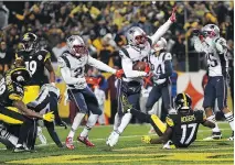  ?? JOE SARGENT/GETTY IMAGES ?? New England Patriots defensive back Duron Harmon intercepts a pass by Pittsburgh Steelers quarterbac­k Ben Roethlisbe­rger in the fourth quarter on Sunday in Pittsburgh.