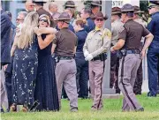  ?? [PHOTO BY CHRIS LANDSBERGE­R, THE OKLAHOMAN] ?? Law enforcemen­t family members gather Monday outside Lloyd Noble Center in Norman for funeral services for Oklahoma Highway Patrol Lt. Donald Heath Meyer. The trooper died of injuries suffered during a pursuit July 14.