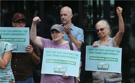  ?? NAncy lAnE pHOTOS / HERAlD STAff ?? FIGHTING FOR CHANGE: Anne Rousseau and Nancy Sableski cheer during a rally to pass the Fair Share Amendment Monday in Boston. Below left, state Sen. Sonia Chang-Diaz speaks during the rally. Below right, City Council candidate Evandro Carvalho snaps a selfie with a poster.