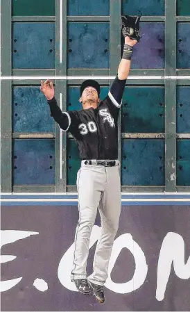  ??  ?? Nicky Delmonico makes a leaping catch at the wall in the fifth inning Wednesday night against the Houston Astros at Minute Maid Park.
| BOB LEVEY/ GETTY IMAGES