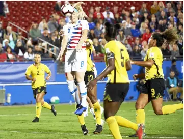  ??  ?? Julie Ertz (top) of the United States scores a goal against Jamaica during the first half of the CONCACAF Women’s Championsh­ip semifinals in Frisco, Texas. — AFP photo