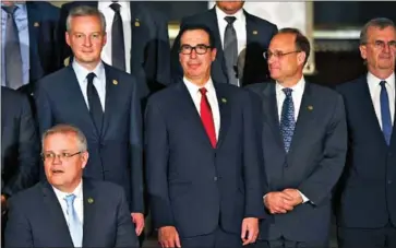  ?? EITAN ABRAMOVICH/AFP ?? France’s Minister of Economy and Finance Bruno Le Maire (back row, left) and US Treasury Secretary Steven Mnuchin (centre) pose for pictures during the G20 finance ministers and central bank governors meeting in Buenos Aires on Saturday.