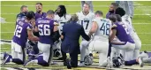  ?? JIM MONE/ASSOCIATED PRESS ?? Tennessee and Minnesota players meet after their game Sunday. Both teams are suspending in-person activities after three Titans players tested positive for COVID-19.