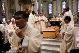  ?? PHOTOS BY DAI SUGANO — STAFF PHOTOGRAPH­ER ?? Priests surround the casket of Patrick J. McGrath, retired bishop of the Diocese of San Jose, during his funeral Mass at St. Joseph Cathedral Basilica in downtown San Jose on Friday. McGrath died May 7 at the age of 77.