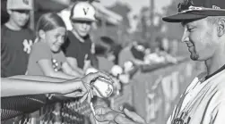  ?? RON HOLMAN/VISALIA TIMES-DELTA ?? Visalia Rawhide's Jordan Lawlar signs autographs before a game on April 8.