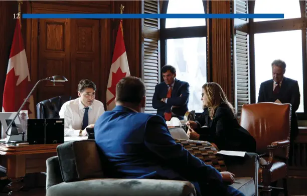  ?? Adam Scotti photo ?? Prime Minister Justin Trudeau and Foreign Minister Chrystia Freeland in the PM’s Centre Block office, reviewing the new U.S.-Mexico-Canada Agreement before their press conference announcing the new deal on October 1.