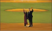  ?? PATRICK T. FALLON — AFP VIA GETTY IMAGES ?? California Gov. Gavin Newsom and his wife, Jennifer Siebel Newsom, wave Tuesday at Dodger Stadium in Los Angeles.