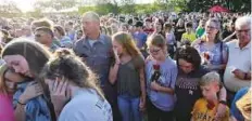  ?? AP ?? Mourners gather during a prayer vigil following a shooting at Santa Fe High School in Santa Fe, Texas, on Friday.