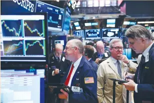  ??  ?? TRADERS WORK on the floor of the New York Stock Exchange last week. Investors will comb economic data over the next few weeks to see if the weak payrolls report reflected a wider trend in the US economy or was an outlier. A first hint of the central...