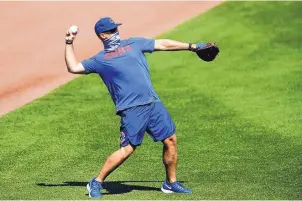  ?? KAMIL KRZACZYNSK­I/ASSOCIATED PRESS ?? Chicago Cubs manager David Ross says the team is adhering to safety protocols that will allow players to shower at Wrigley Field.
