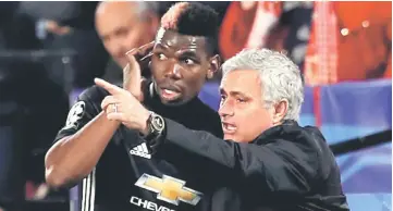  ??  ?? File photo of Manchester United manager Jose Mourinho speaking with Paul Pogba during a match. — Reuters photo