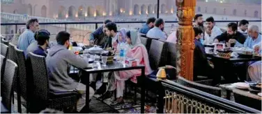  ?? ?? People break their fast at a rooftop restaurant in Lahore on Friday. Associated Press