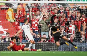  ?? — Reuter ?? Nick of time: Burnley goalkeeper Nick Pope saving a close-range attempt from Liverpool’s Dominic Solanke (on ground).