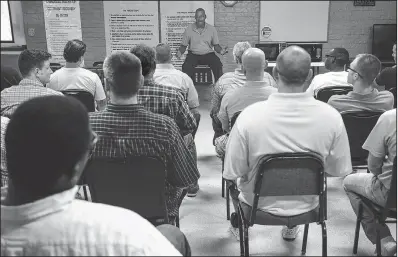  ?? Arkansas Democrat-Gazette/MITCHELL PE MASILUN ?? Sam Hammons, assistant director of Covenant Recovery in Malvern, speaks to prisoners during one of their group sessions at the center July 20.