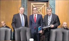  ?? Tasos Katopodis Getty Images ?? SEN. MIKE CRAPO, left, and Sen. Sherrod Brown, right, are working on a Dodd-Frank reform bill. With them is Treasury Secretary Steven T. Mnuchin.