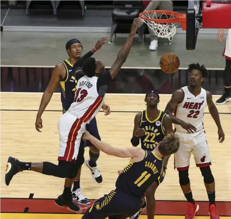  ?? AP ?? BAM FOR THE SLAM: Miami Heat center Bam Adebayo (13) dunks over Indiana Pacers forward Domantas Sabonis (11) in the third quarter Sunday at AmericanAi­rlines Arena in Miami.