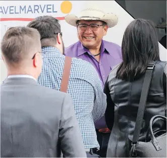  ?? GAVIN YOUNG ?? Tsuut’ina Chief Lee Crowchild greets guests before a bus tour of new developmen­t on the reserve southwest of Calgary. The evening also included a dinner with elders and young native artists.