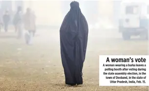  ??  ?? A woman wearing a burka leaves a polling booth after voting during the state assembly election, in the town of Deoband, in the state of Uttar Pradesh, India, Feb. 15.