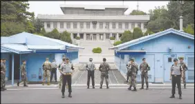  ?? AP PHOTO ?? South Korea and U.S. soldiers stand guard during a commemorat­ive ceremony for the 64th anniversar­y of the signing of the Korean War Armistice Agreement at the truce village of Panmunjom in the Demilitari­zed Zone.