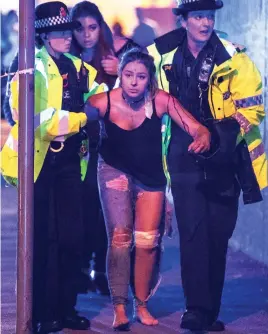  ??  ?? Carnage: Police helping a stunned Manchester bomb survivor