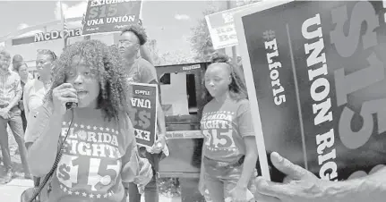  ?? FILE ?? Noji Olaigbe, left, from the Fight for $15 minimum wage movement, speaks during a workers’ strike at a McDonald’s in Fort Lauderdale in 2019.