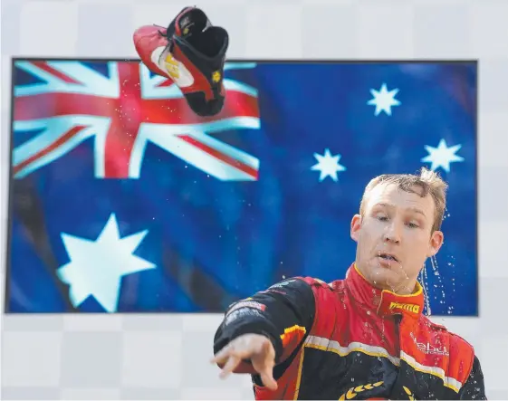  ?? Picture: GETTY IMAGES ?? Race winner David Reynolds throws his boot after drinking champagne from it on the podium.