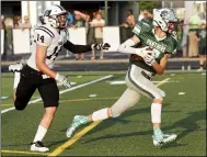  ?? RANDY MEYERS — FOR THE MORNING JOURNAL ?? Elyria Catholic’s Colin Ginley makes the catch and breaks away from Drake Venerucci of Perkins to score the first touchdown at EC’s new stadium turf Aug. 27.